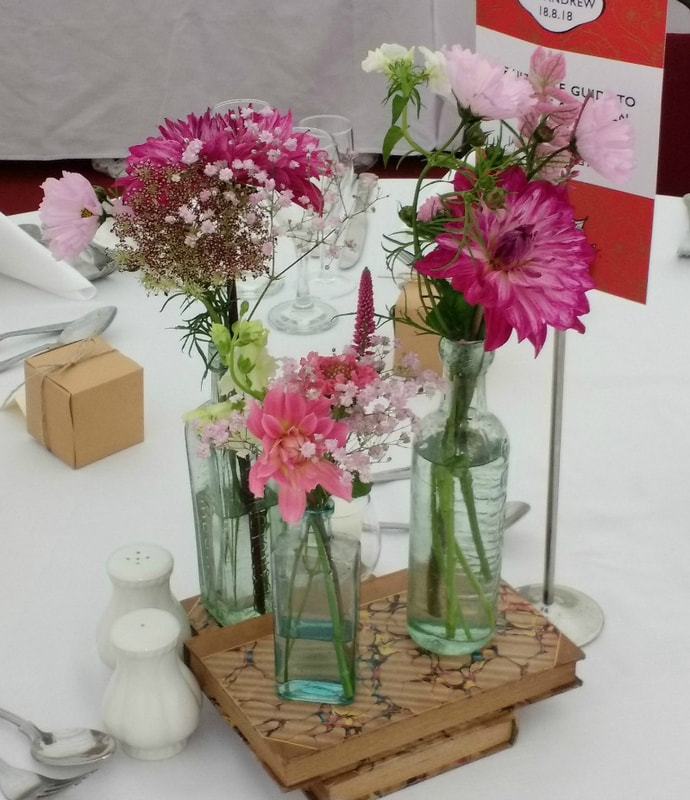 Table decor of vintage glass bottles & summer flowers grown in Scotland for a country wedding copyright www.GallowayFlowers.co.uk