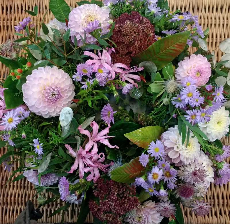 A pretty pink & lilac coloured natural wreath. Wreath of Pink Dahlias, Nerines, Michaelmas Daisies. Copyright www.GallowayFlowers.co.uk