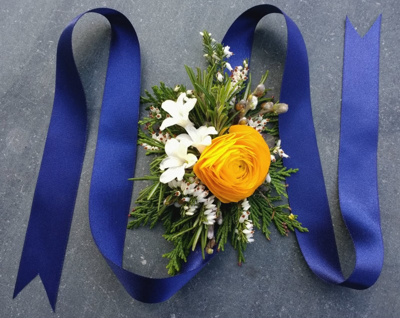 Stunning floral wrist corsage in yellow, white & navy blue