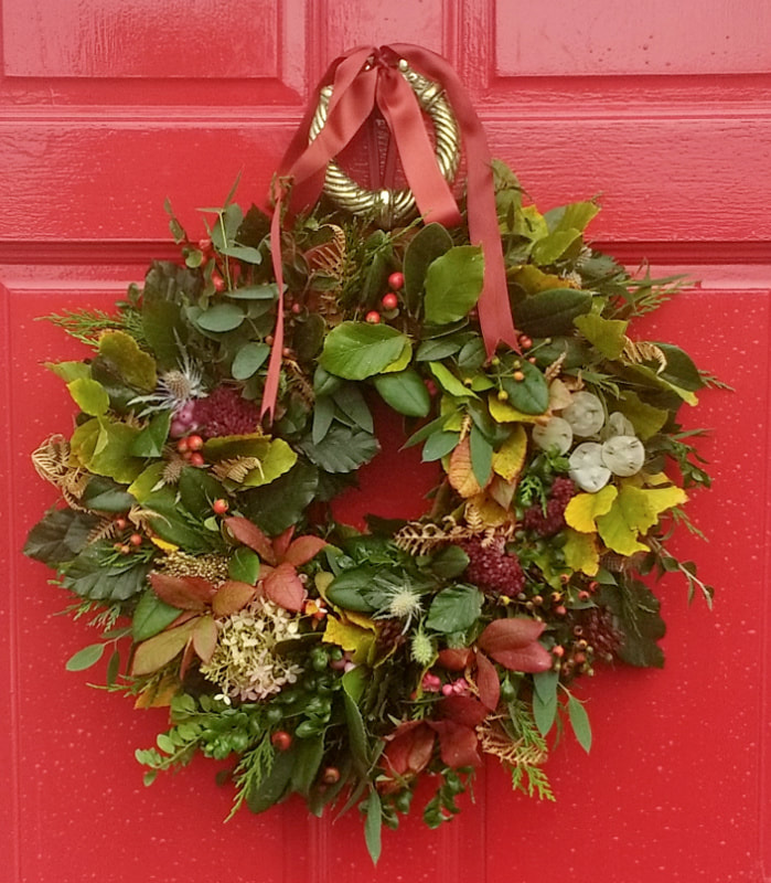 Autumn Wreath of seasonally tinted foliage & berries on red door, florist castle douglas, florist dumfries & galloway, copyright Rosie Gray, www.GallowayFlowers.co.uk