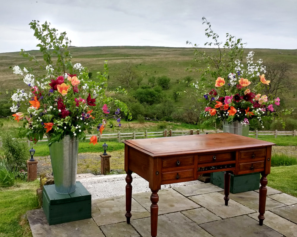 Ceremony area for a relaxed Garden Wedding with brightly coloured flowers in May. Copyright www.GallowayFlowers.co.uk