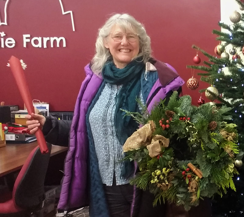 Proud wreathmaker with her wreath after Christmas wreath workshop at Ernespie Farm Shop, Castle Douglas, Dumfries & Galloway.  copyright www.gallowayflowers.co.uk