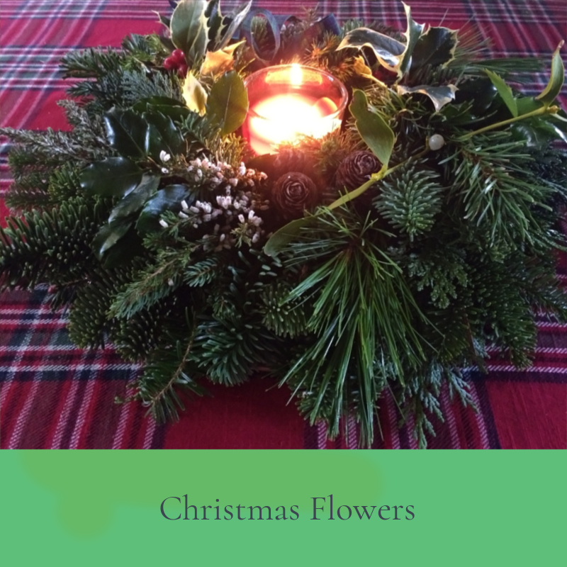 Handmade Christmas table wreath with candle in centre. Copyright www.GallowayFlowers.co.uk