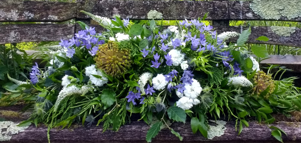 Natural casket spray for funeral with blue & white Summer flowers, all locally grown & seedheads. Copyright www.GallowayFlowers.co.uk