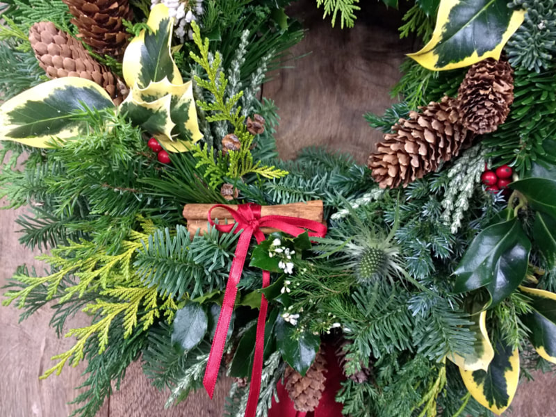 Handmade Christmas Wreath with cones, berries & cinnamon sticks. Copyright www.GallowayFlowers.co.uk