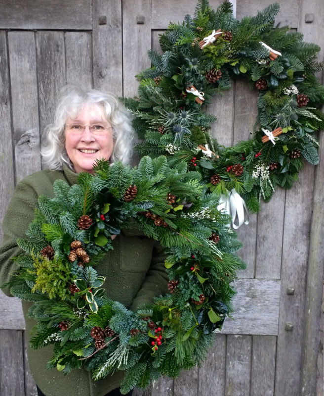 Rosie Gray, Flower Farmer & Florist with Giant hanmade Christmas Wreaths. Copyright www.GallowayFlowers.co.uk