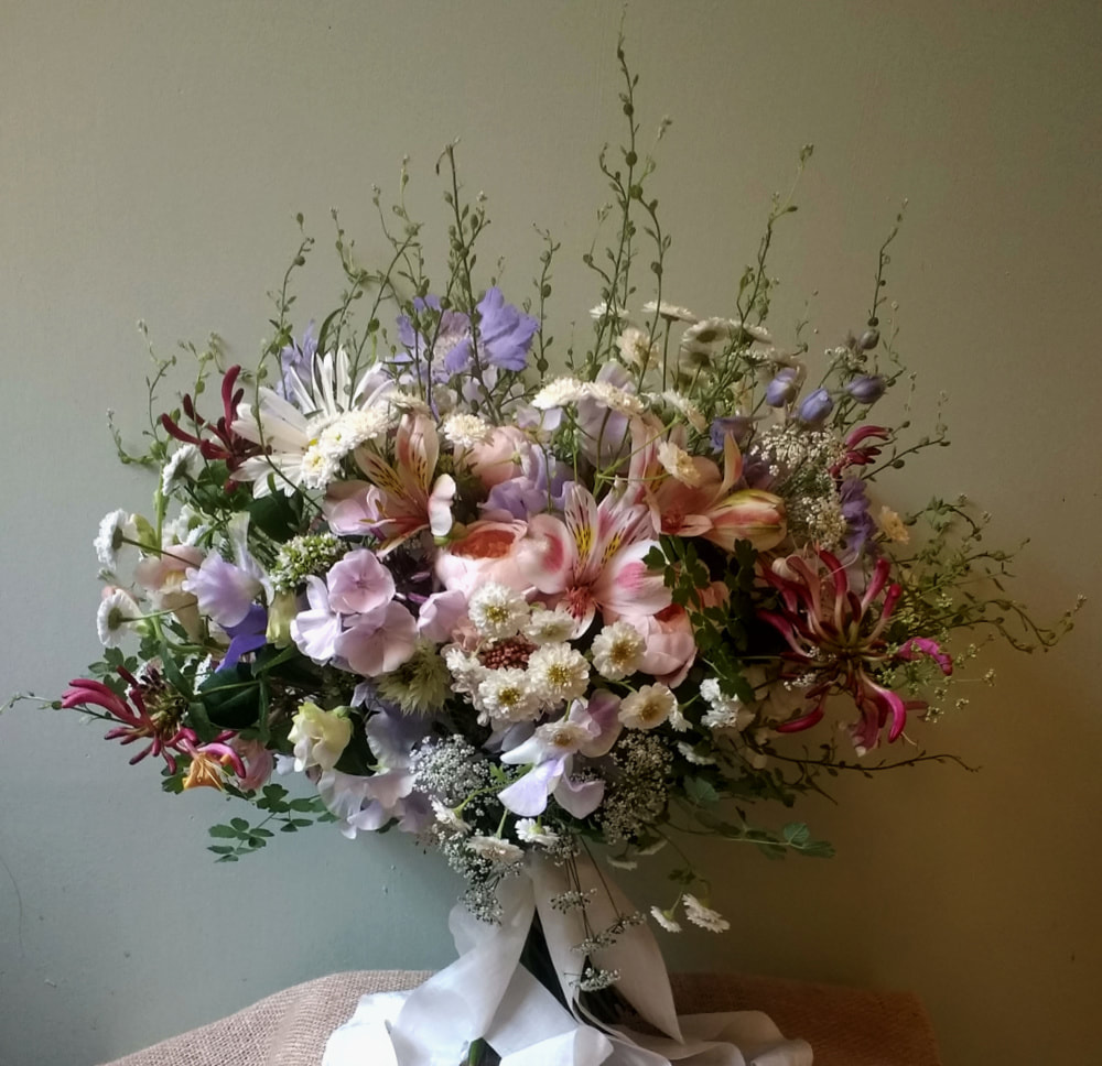 Bridal Bouquet of locally grown July flowers in soft pink & blue. Includes garden roses, daisies Sweet Peas & Honeysuckle. Copyright www.GallowayFlowers.co.uk